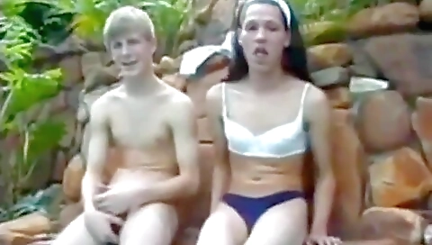 Horny brunette is playing with her boyfriend's cock outdoors