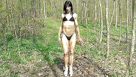 Amateur brunette girl in a sexy dress in a hot outdoor video